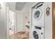 Modern laundry closet with stacked washer and dryer, conveniently located near bedrooms at 8155 E Roosevelt St # 112, Scottsdale, AZ 85257