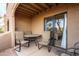 Cozy covered patio with seating area, perfect for outdoor dining and relaxation with sliding glass door at 8155 E Roosevelt St # 112, Scottsdale, AZ 85257