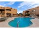 Community pool with beautiful landscaping and inviting lounge chairs for relaxing by the water at 8155 E Roosevelt St # 112, Scottsdale, AZ 85257
