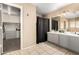 Spacious bathroom features dual sinks, vanity, walk-in closet, and neutral tile floors at 8812 N 67Th Dr, Peoria, AZ 85345