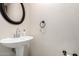 A close-up shot of a bathroom sink and faucet, plus a black oval mirror at 8812 N 67Th Dr, Peoria, AZ 85345