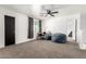 Bright open bedroom with neutral carpet, a ceiling fan, plus a space for an office at 8812 N 67Th Dr, Peoria, AZ 85345