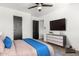 Minimalist bedroom with sleek dresser, mounted TV, and serene decor at 8812 N 67Th Dr, Peoria, AZ 85345