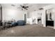 Bright open bedroom with neutral carpet, a ceiling fan, plus a space for an office at 8812 N 67Th Dr, Peoria, AZ 85345