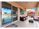 Covered patio seating area with ceiling fan overlooks the backyard and pool with easy access to the home at 8812 N 67Th Dr, Peoria, AZ 85345