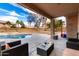 Enjoy this covered patio area with direct view of the sparkling pool and easy access to the yard at 8812 N 67Th Dr, Peoria, AZ 85345