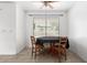 The dining room features a table with four chairs and a window providing natural light at 8812 N 67Th Dr, Peoria, AZ 85345