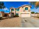 Traditional two-story home with a well-kept lawn, complemented by desert landscaping at 8812 N 67Th Dr, Peoria, AZ 85345