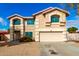 Charming two-story home with an attached two car garage, desert landscaping, and teal window frames at 8812 N 67Th Dr, Peoria, AZ 85345
