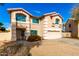 Charming two-story home with an attached two car garage, desert landscaping, and teal window frames at 8812 N 67Th Dr, Peoria, AZ 85345