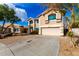 Charming two-story home with an attached two-car garage, desert landscaping, and teal window frames at 8812 N 67Th Dr, Peoria, AZ 85345