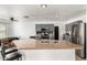 This kitchen features stainless steel appliances, an island, bar seating and dark wood cabinets at 8812 N 67Th Dr, Peoria, AZ 85345