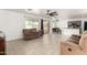 Open-concept living room featuring a comfortable sofa, tiled floor, and natural light at 8812 N 67Th Dr, Peoria, AZ 85345