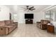 Spacious living room with a ceiling fan, tile floors, two couches and a television at 8812 N 67Th Dr, Peoria, AZ 85345
