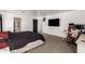 Main bedroom with a bed, tv, and a desk for a bright workspace at 8812 N 67Th Dr, Peoria, AZ 85345