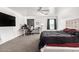 Large bedroom with carpet, ceiling fan, TV, bed and a desk at 8812 N 67Th Dr, Peoria, AZ 85345