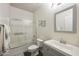 Bright bathroom features a tub with shower, single sink vanity, modern fixtures and gray color palette at 9065 E Gary Rd # 121, Scottsdale, AZ 85260