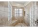Modern bathroom with glass blocked window, tiled shower with built-in shelf and shower head at 9065 E Gary Rd # 121, Scottsdale, AZ 85260