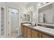 Bright bathroom features dual sinks with modern fixtures, vanity with wood cabinets, and great lighting at 9065 E Gary Rd # 121, Scottsdale, AZ 85260