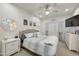 Cozy main bedroom offers a large bed, a ceiling fan, decorative mirror, and great natural lighting at 9065 E Gary Rd # 121, Scottsdale, AZ 85260