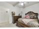 Bedroom with a ceiling fan, plush carpet, a beautifully decorated bed, and a dresser at 9065 E Gary Rd # 121, Scottsdale, AZ 85260