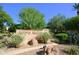 Arroyo Madera community entrance sign featuring desert landscaping and mature trees under a clear blue sky at 9065 E Gary Rd # 121, Scottsdale, AZ 85260