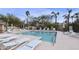 Inviting community pool and sun deck surrounded by lounge chairs, palm trees, and desert landscape at 9065 E Gary Rd # 121, Scottsdale, AZ 85260
