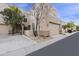 Inviting townhome featuring a two-car garage, desert landscaping, and a cozy front porch at 9065 E Gary Rd # 121, Scottsdale, AZ 85260