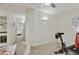 Upper landing area with neutral carpet, open to the lower level, with home exercise equipment at 9065 E Gary Rd # 121, Scottsdale, AZ 85260