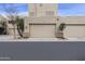 Exterior view of garages featuring desert-style architecture with neutral colors, landscaping, and ample parking at 9065 E Gary Rd # 121, Scottsdale, AZ 85260