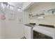 Laundry room with side by side washer and dryer and built in storage shelves at 9065 E Gary Rd # 121, Scottsdale, AZ 85260