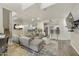 Open concept living room with a large mirrored wall, comfortable seating, and access to the kitchen area at 9065 E Gary Rd # 121, Scottsdale, AZ 85260