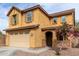 Charming two-story home with tan stucco, brown roof and shutters, and a two car garage at 9080 W Myrtle Ave, Glendale, AZ 85305