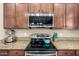 Close-up showcasing the modern range, granite countertops and stylish cabinets, highlighting the kitchen's functionality at 9080 W Myrtle Ave, Glendale, AZ 85305