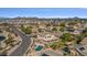 Aerial view of property with pool, covered patio, lush lawn, and mountain views at 9237 W Alex Ave, Peoria, AZ 85382