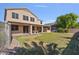 Expansive backyard showcasing a covered patio, well-maintained lawn, and mature landscaping for outdoor enjoyment at 9237 W Alex Ave, Peoria, AZ 85382