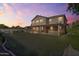 Spacious backyard featuring lush lawn, covered patio, and privacy landscaping at 9237 W Alex Ave, Peoria, AZ 85382