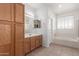 Bright bathroom with dual sinks, soaking tub and updated vanity at 9237 W Alex Ave, Peoria, AZ 85382