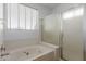 Close up of a soaking tub and shower in a modern bathroom at 9237 W Alex Ave, Peoria, AZ 85382