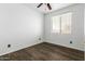 Hardwood floor bedroom with a ceiling fan and a large window with blinds for light control at 9237 W Alex Ave, Peoria, AZ 85382