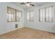 Clean bedroom featuring tile flooring and three large windows at 9237 W Alex Ave, Peoria, AZ 85382