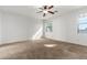 Sunny bedroom featuring neutral walls and neutral carpet at 9237 W Alex Ave, Peoria, AZ 85382