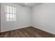 This bedroom offers wood-look floors and a window with blinds at 9237 W Alex Ave, Peoria, AZ 85382