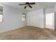 A comfortable bedroom with carpet features a ceiling fan, closet, and natural light from the windows at 9237 W Alex Ave, Peoria, AZ 85382