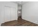 This bright bedroom features wood-look floors and a double closet at 9237 W Alex Ave, Peoria, AZ 85382