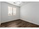 Hardwood floor bedroom with a ceiling fan and a window with blinds, bright and airy at 9237 W Alex Ave, Peoria, AZ 85382