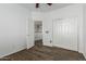 Hardwood floor bedroom with a ceiling fan and a sliding door closet, bright and airy at 9237 W Alex Ave, Peoria, AZ 85382