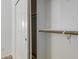 This closet features white sliding doors and wood shelving at 9237 W Alex Ave, Peoria, AZ 85382