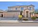 Inviting two-story home with a three-car garage and well-maintained landscaping at 9237 W Alex Ave, Peoria, AZ 85382