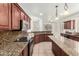 Open kitchen with granite countertops and stainless steel appliances at 9237 W Alex Ave, Peoria, AZ 85382